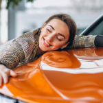 a woman hugging her car
