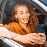 a woman in a stationary car, digitally updating her licence on here phone