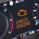 an orange check engine light to highlight the importance of having an extended car warranty