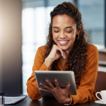 A women smiling while managing her insurance policy online