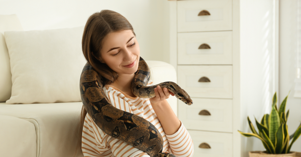 a women holding her pet snake who is protected with pet insurance for exotic animals