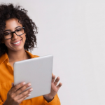 A female where an orange top and using her tablet to save on her car insurance premiums online