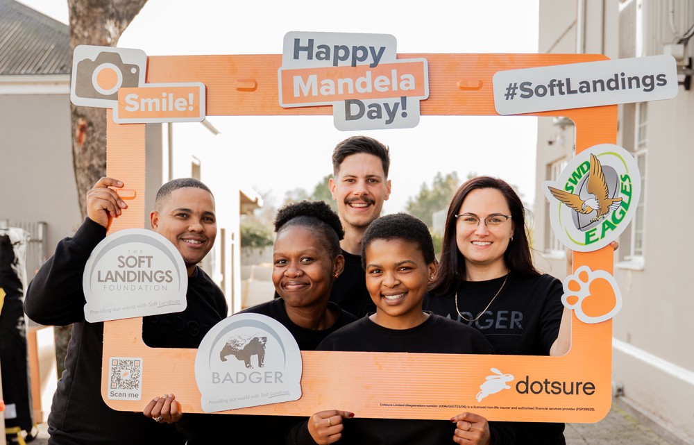 Dotsure employees celebrating after the Mandela Day Food Packing Drive where over 13,000 food packs were made in George.
